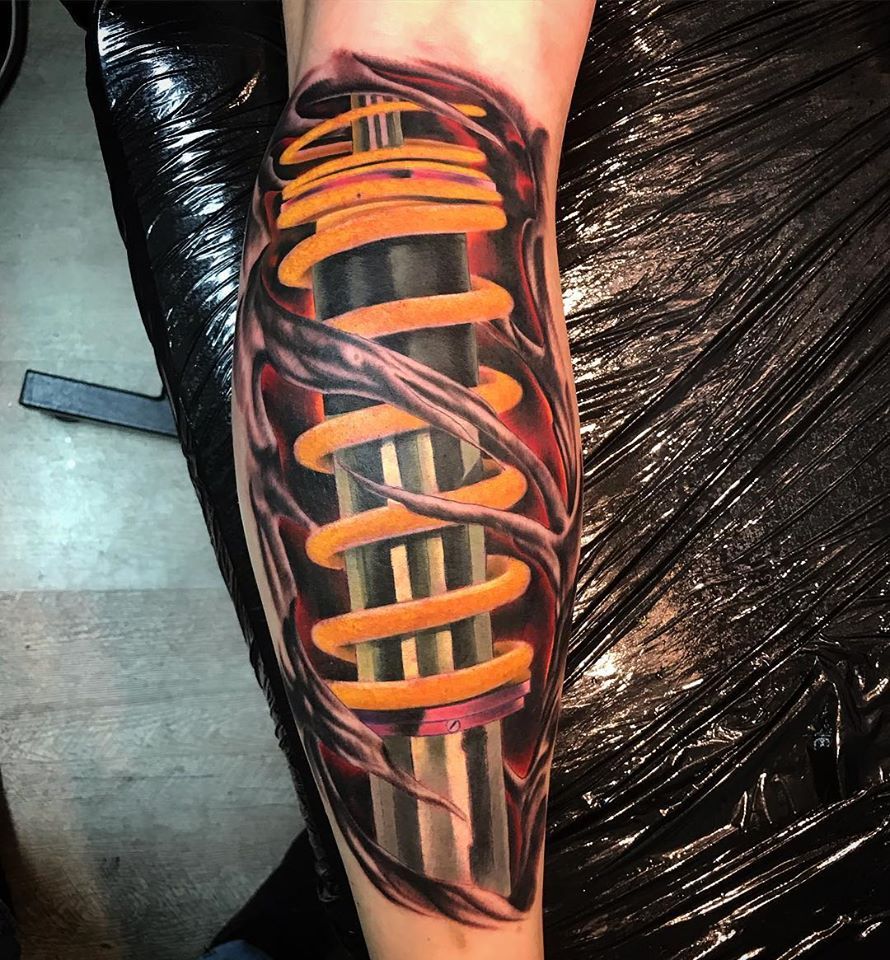 a cover-up tattoo with a black and orange design on the arm, esslingen, germany