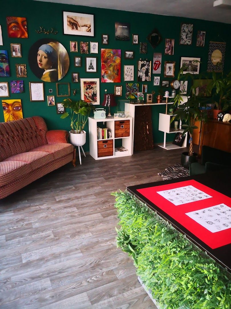 a living room with green walls and a red rug