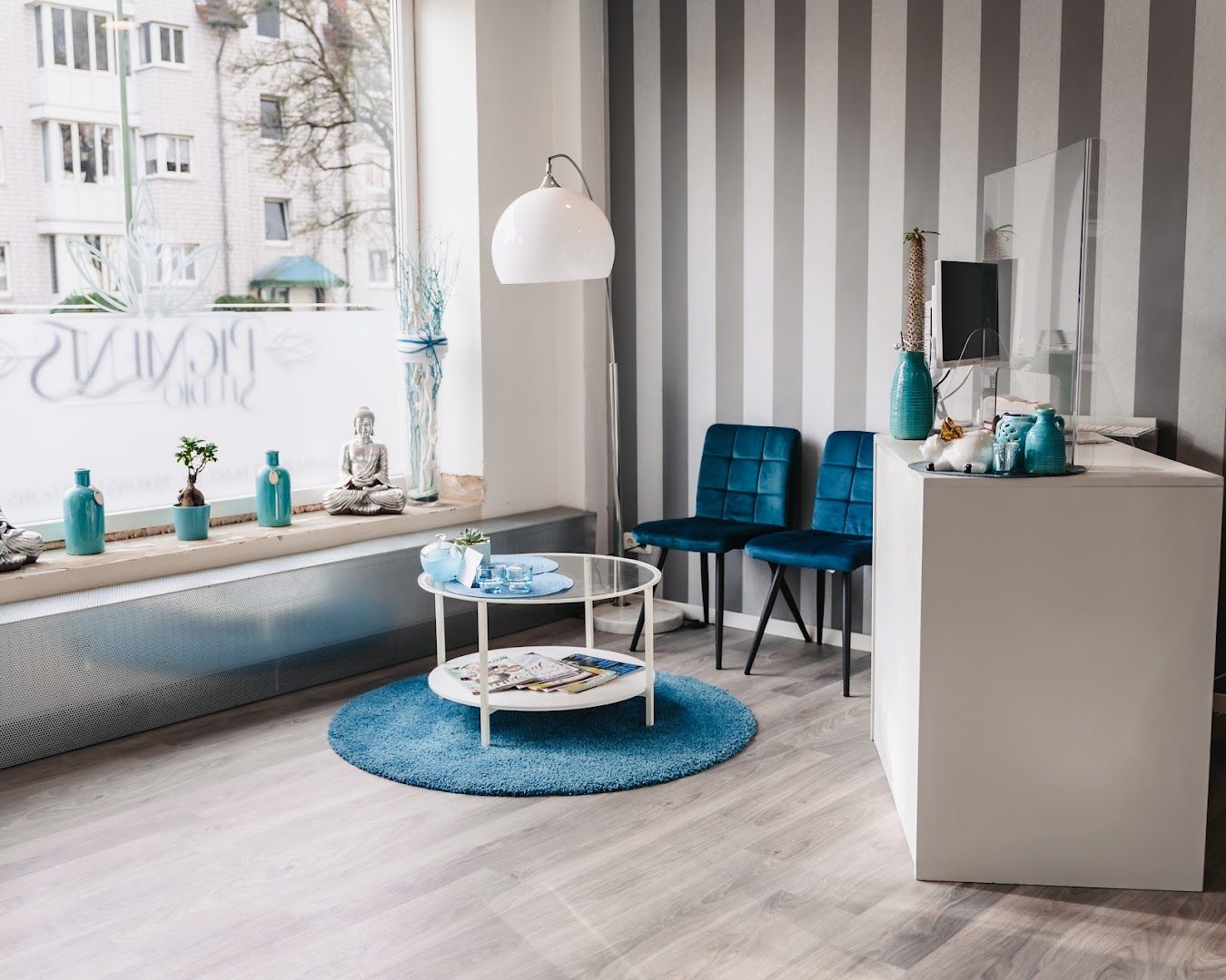 a living room with a blue and white striped wallpaper