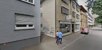 a street with buildings and people walking on it