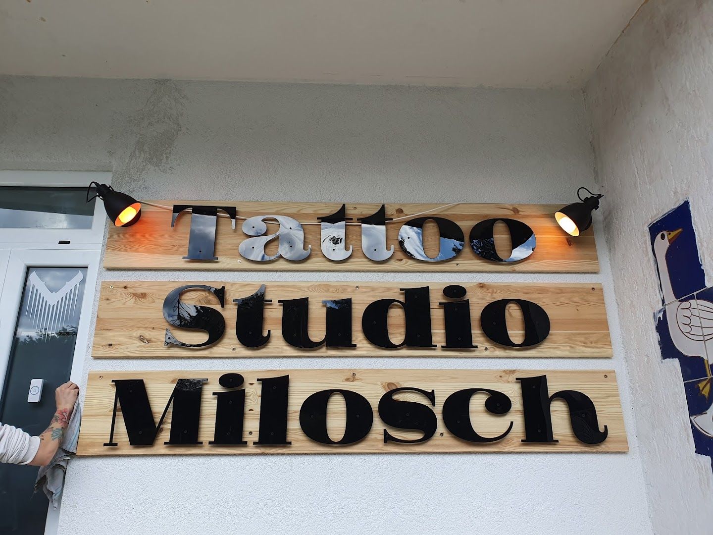 a man is standing in front of a sign that says studio
