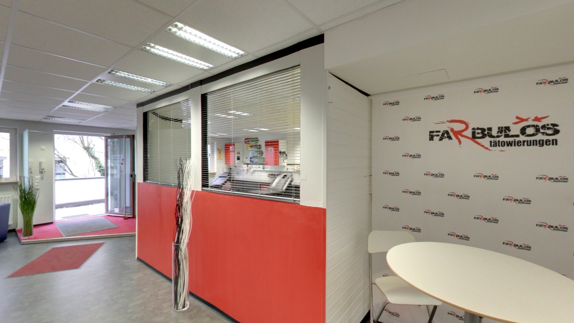 a red and white office with a white table