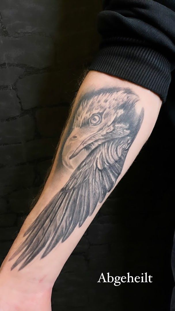 a black and white cover-up tattoo of a bird on the arm, delmenhorst, germany