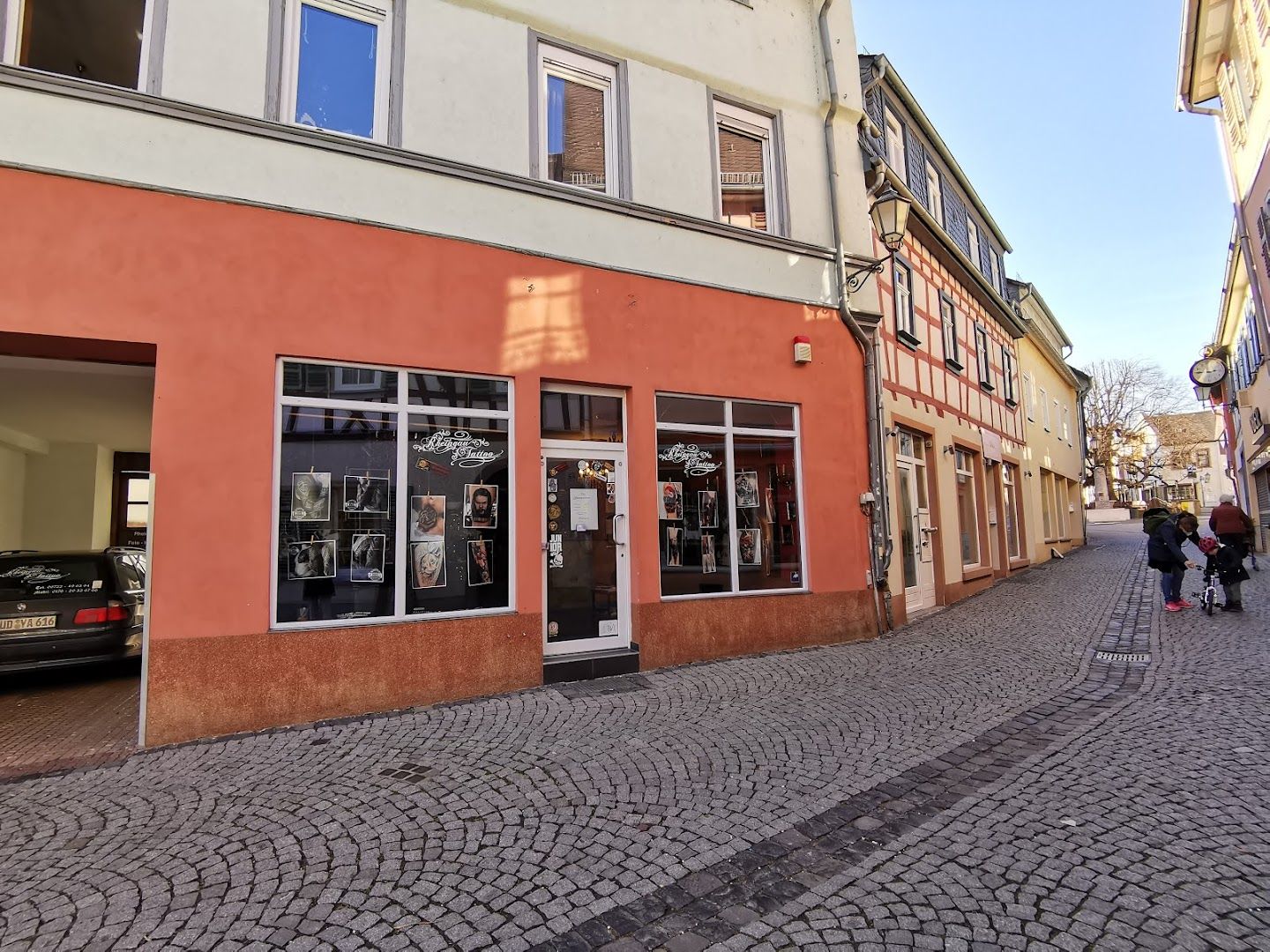 a street with buildings and a car parked in front