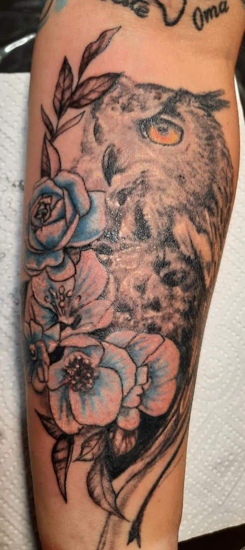 a wolf with flowers on his arm