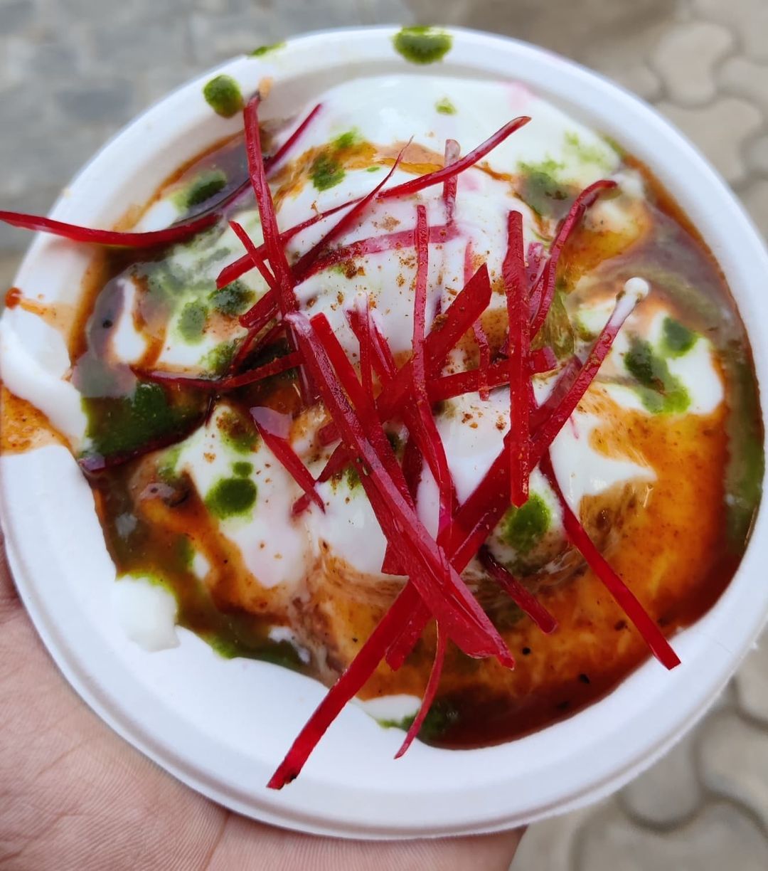 A bowl of dahi bhalla with yoghurt, chutneys and beetroot garnish from the chaat counter at Rangmanch Farms, an outdoor event venue in Gurugram near Delhi