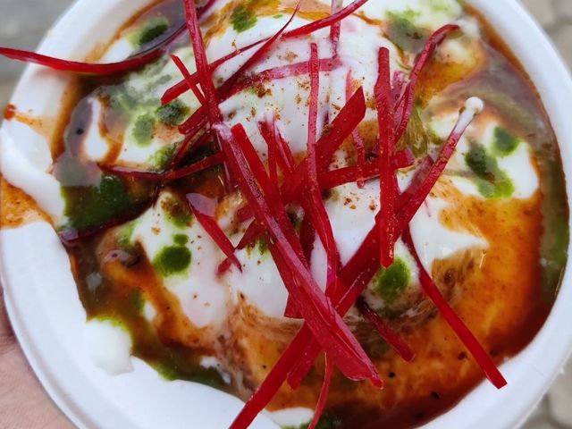 A bowl of dahi bhalla with yoghurt, chutneys and beetroot garnish from the chaat counter at Rangmanch Farms, an outdoor event venue in Gurugram near Delhi