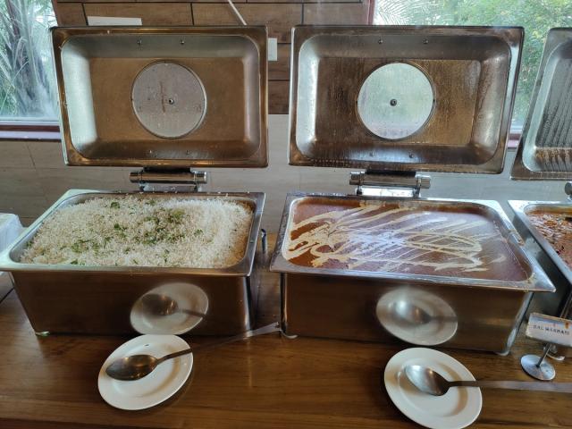 Rice and dal on the main course counter of the corporate lunch buffet — corporate outing venue with all meals included, Gurugram