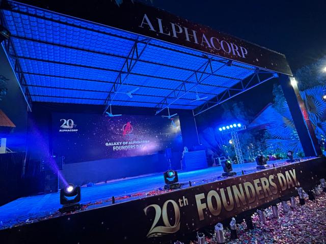 Corporate event stage with truss lighting set up before guests arrive — corporate annual day venue near Delhi, Rangmanch Farms