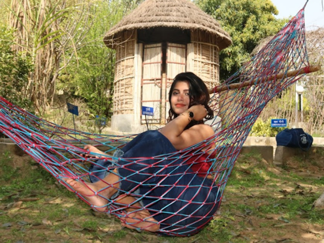 A guest relaxing in a hammock at Rangmanch Farms