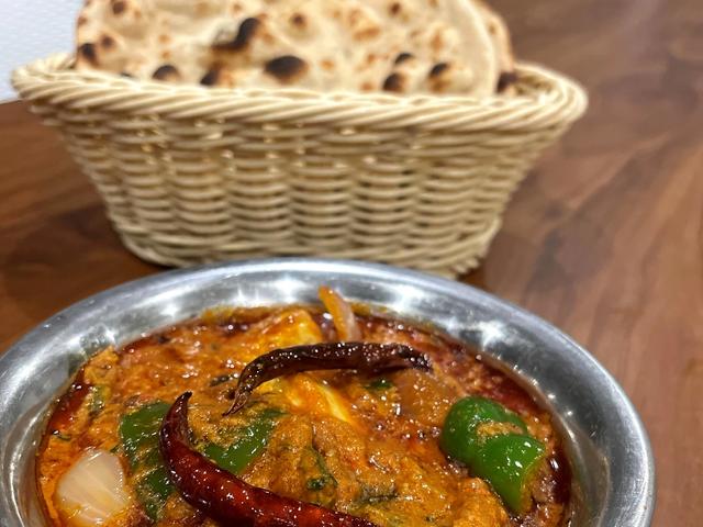 Main course curry in a bowl served with a basket of tandoori roti from the buffet at Rangmanch Farms, an outdoor event venue in Gurugram near Delhi