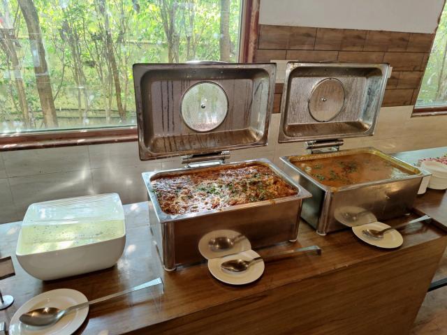 Main course dishes and accompaniments on the buffet at a corporate offsite — corporate lunch venue in Gurugram