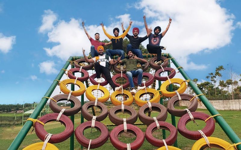 A group on the rope pyramid at Rangmanch Farms