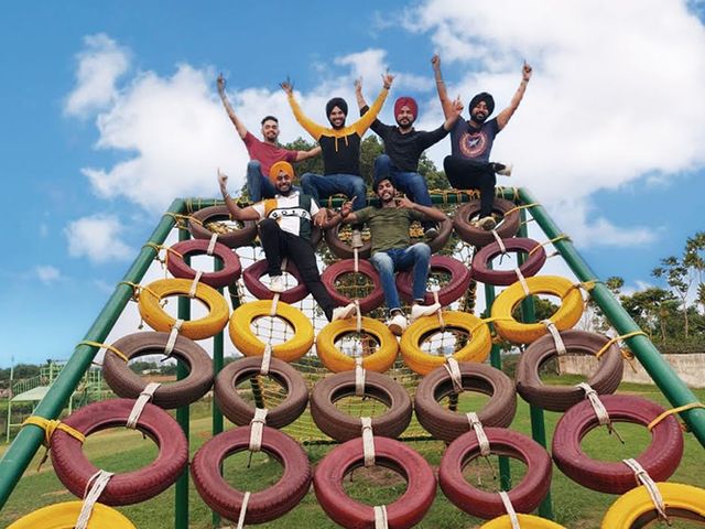 A group on the rope pyramid at Rangmanch Farms