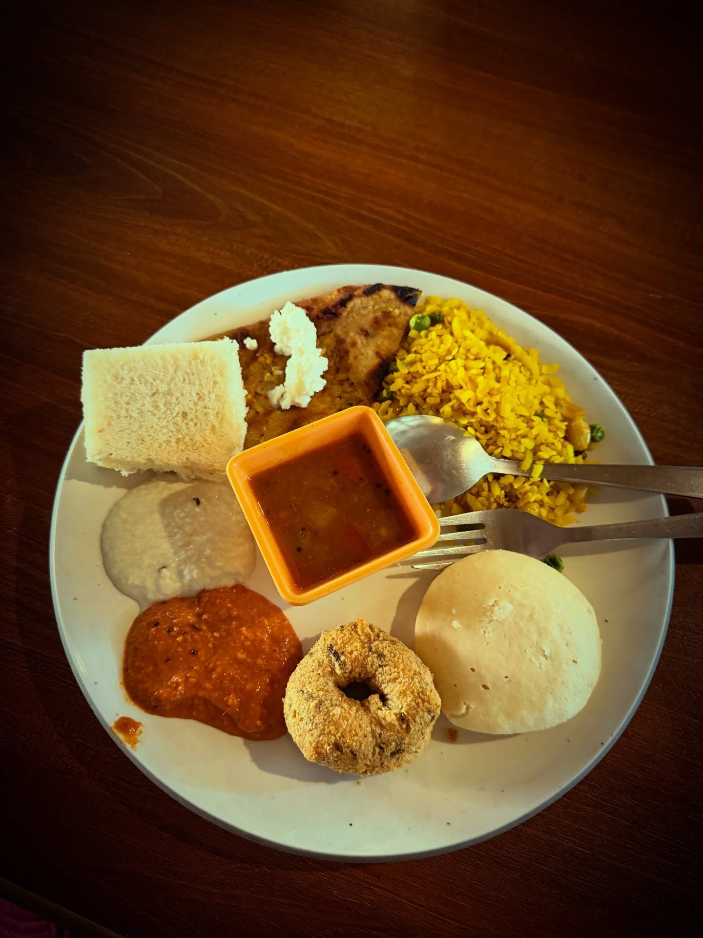A South Indian breakfast plate with idli, vada, chutneys, sambar and rice from the buffet at Rangmanch Farms, an outdoor event venue in Gurugram near Delhi