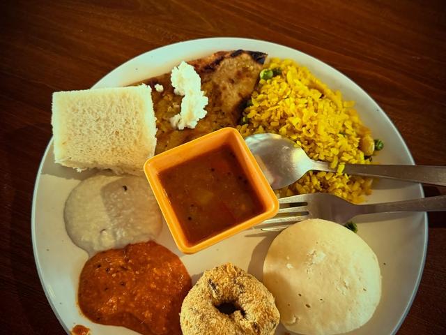 A South Indian breakfast plate with idli, vada, chutneys, sambar and rice from the buffet at Rangmanch Farms, an outdoor event venue in Gurugram near Delhi