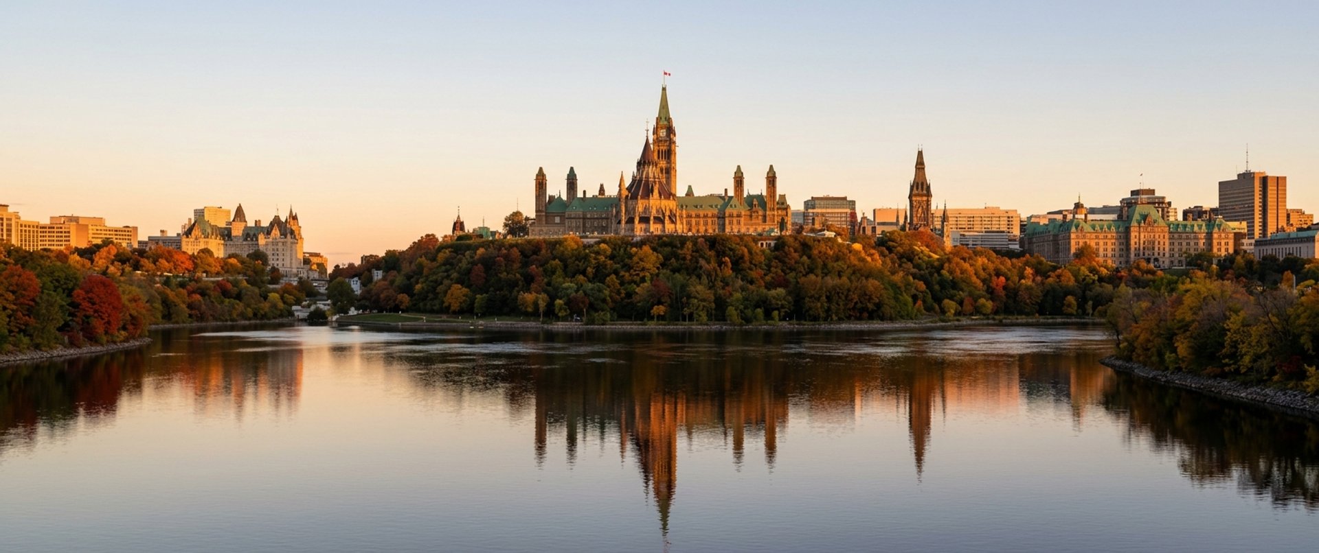Ottawa skyline at sunset with Parliament Hill above the Ottawa River