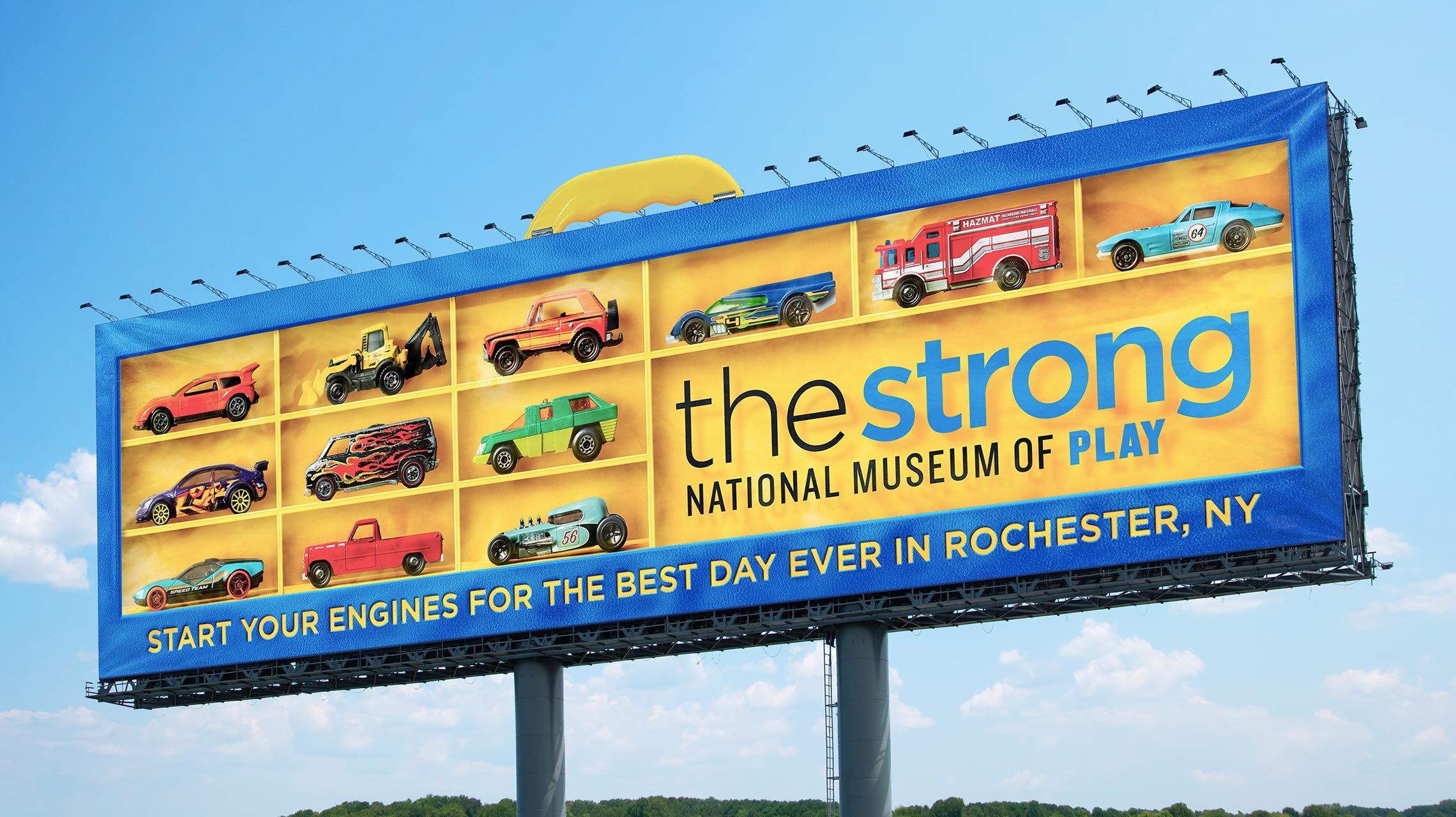 Billboard for The Strong National Museum of Play that looks like a carrying case for Hot Wheels miniature car toys.