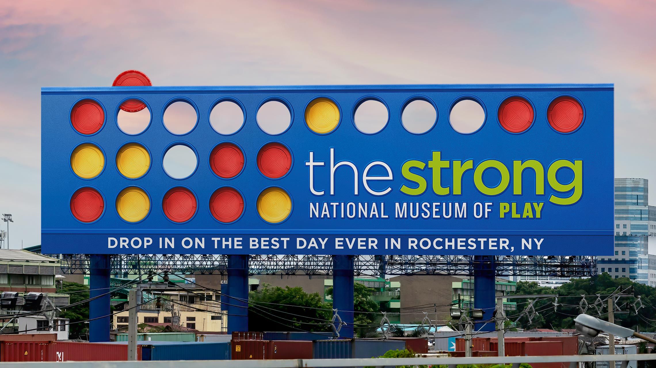 Billboard for The Strong National Museum of Play that looks like the board game Connect Four.