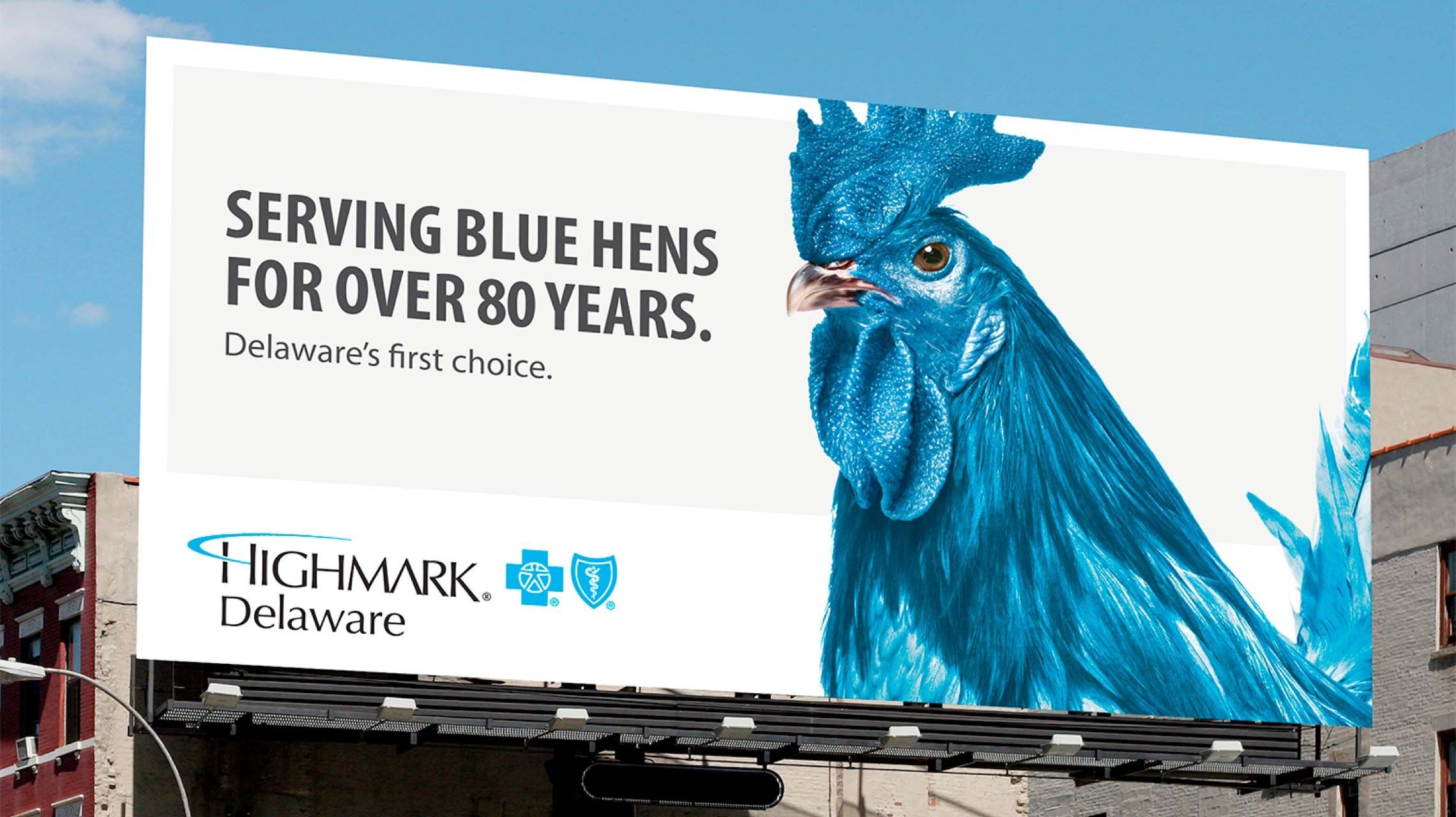 Photograph of a blue hen billboard that says, "Serving blue hens for over 80 years. Delaware's first choice."