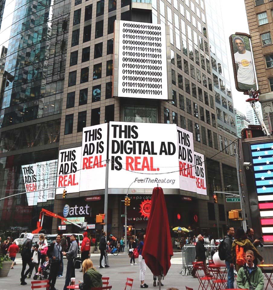 "This digital ad is real" advertisements on a building.
