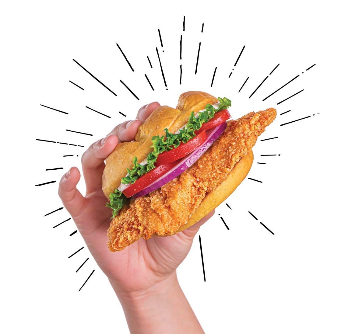 Hand holding up a Crispy Chicken Smash sandwich.