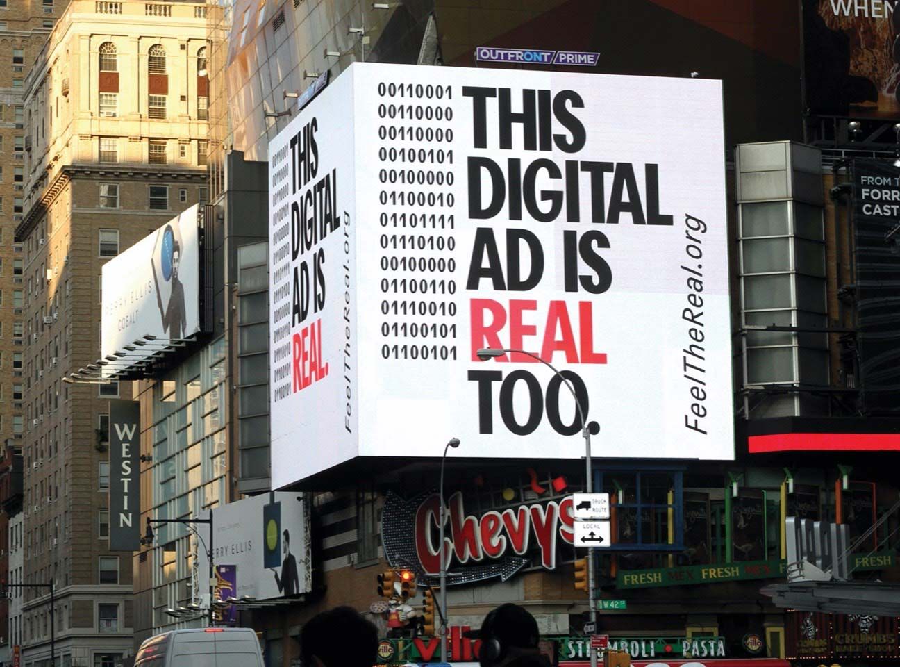 "This digital ad is real, too" advertisements on a building.