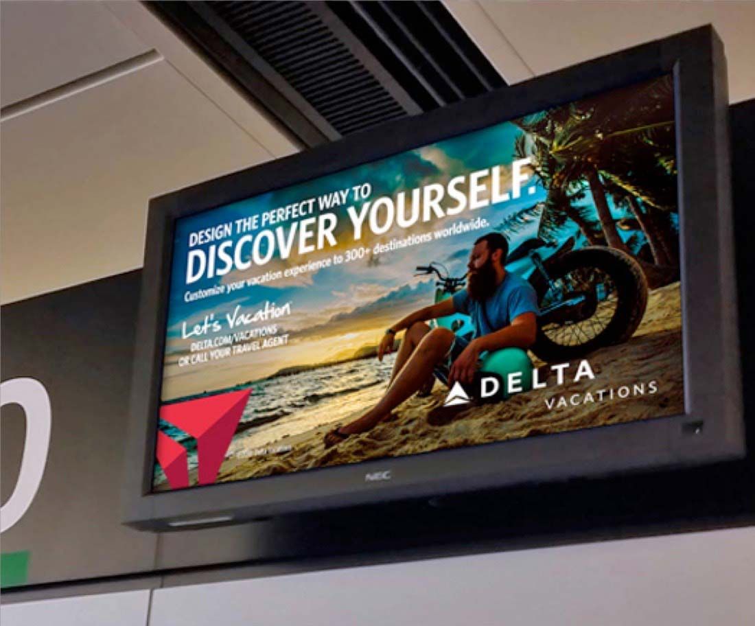Delta Vacations advertisement in an airport terminal.