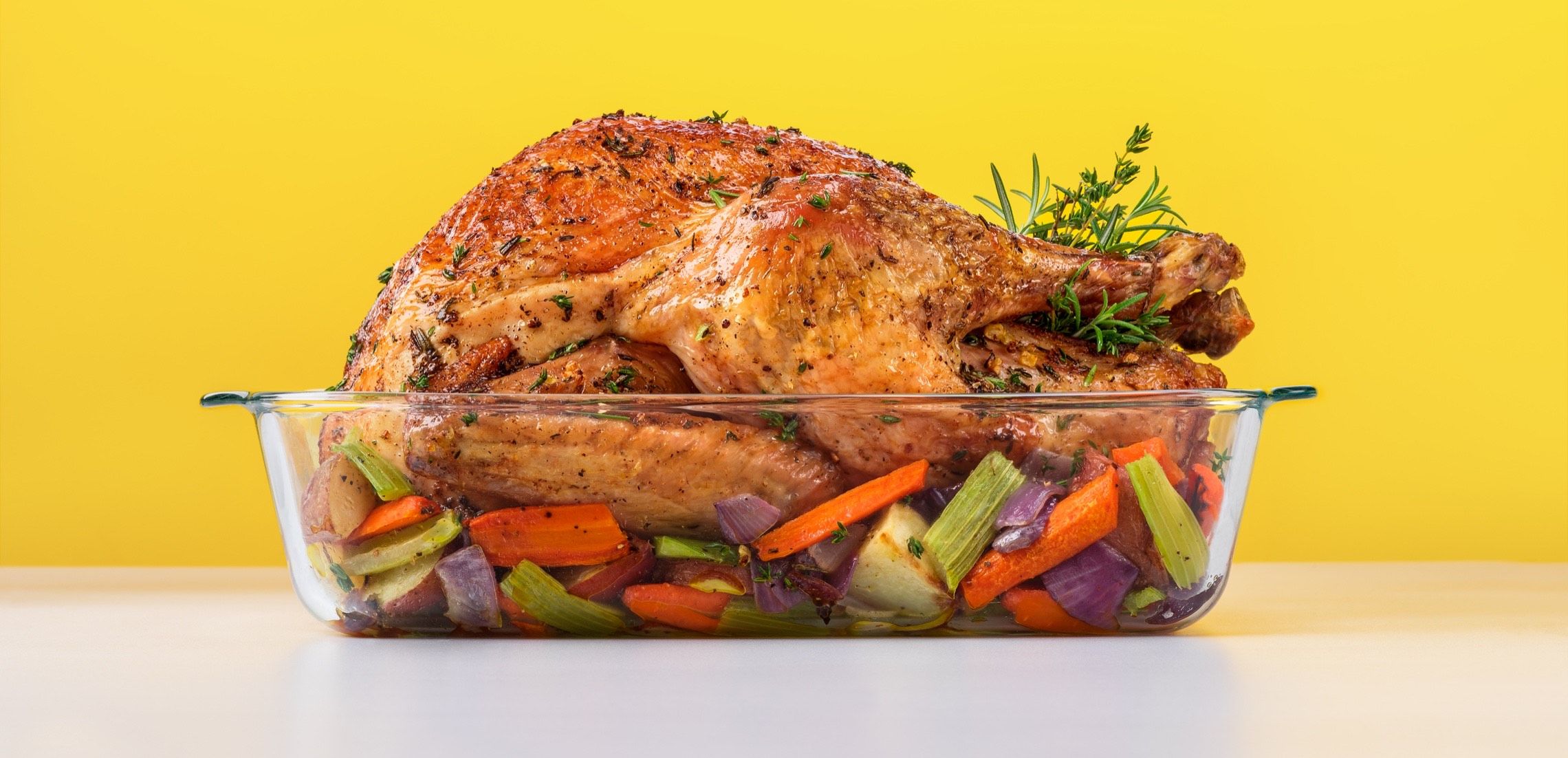 Photograph of a roast turkey and vegetables in a Pyrex Deep dish.