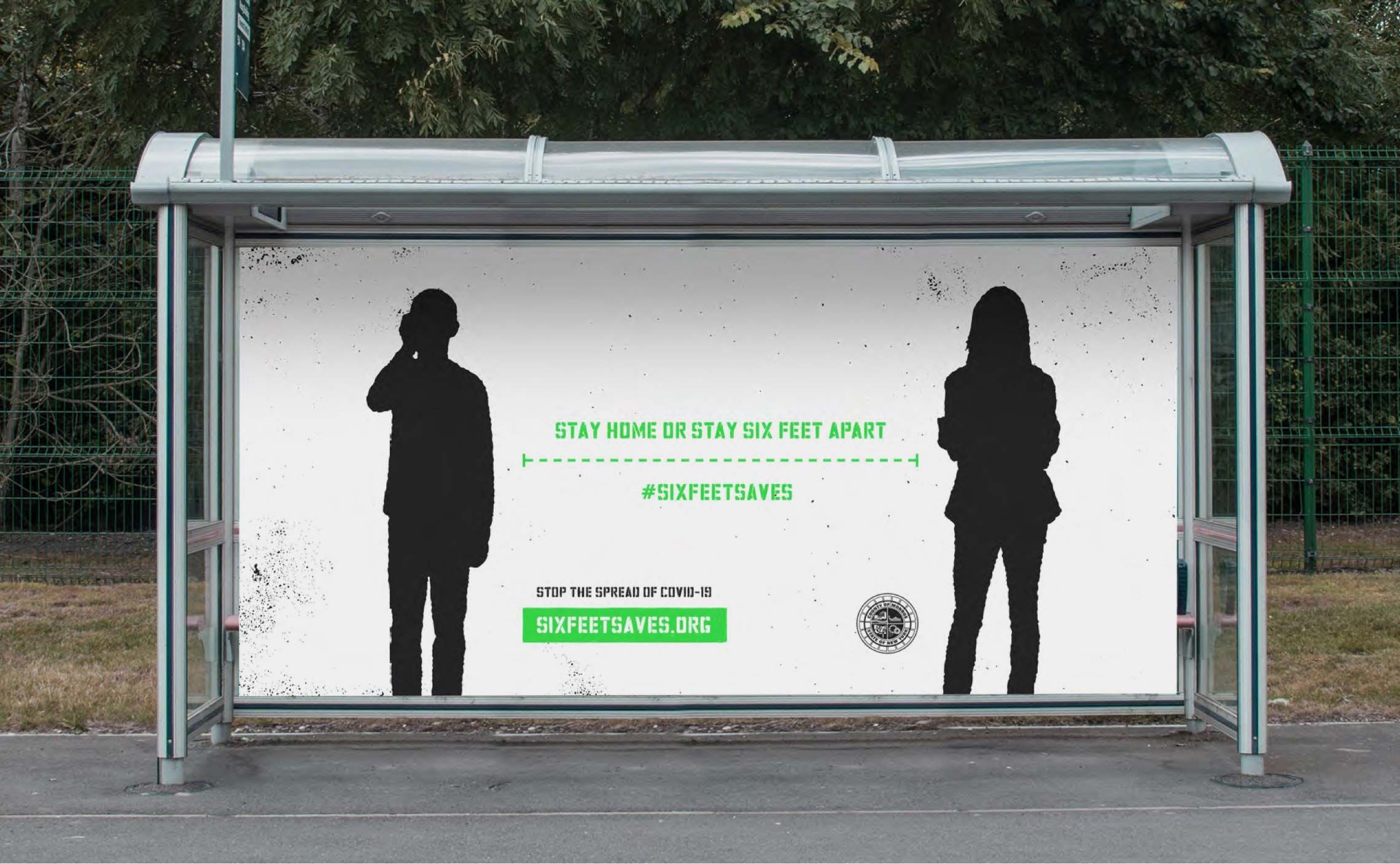 Photograph of a Six Feet Saves ad on a bus shelter showing two silhouettes exactly six feet apart. It says, "Stay home or stay six feet apart."