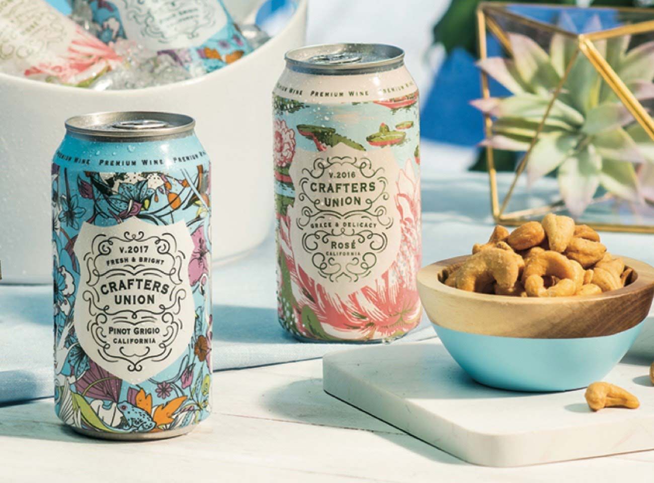 Photograph of two Crafters Union cans in an outdoor tropical setting.