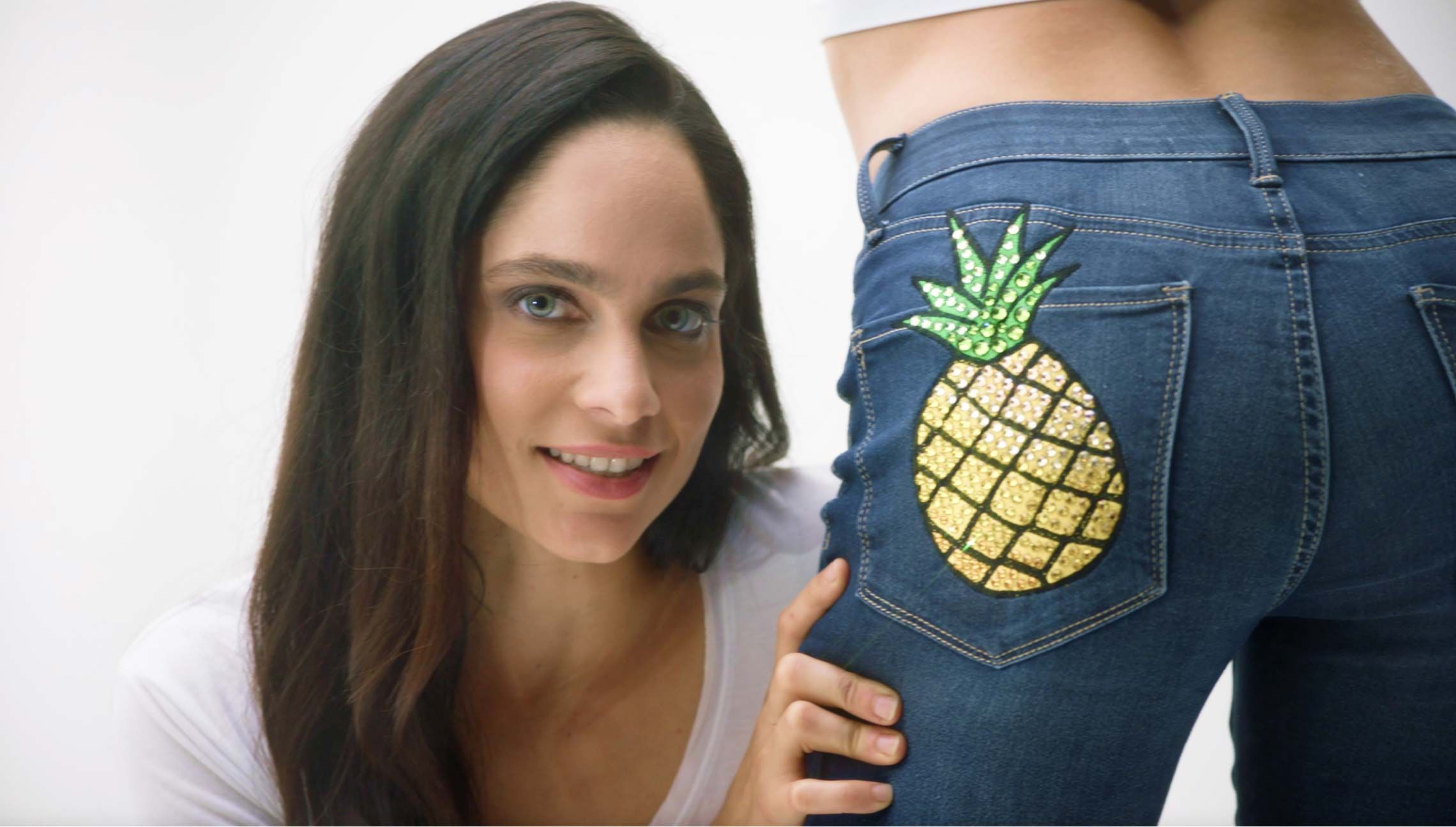 Photograph of a girl with a pineapple bedazzled on the butt of her jeans. Click to view one of the television advertisements.