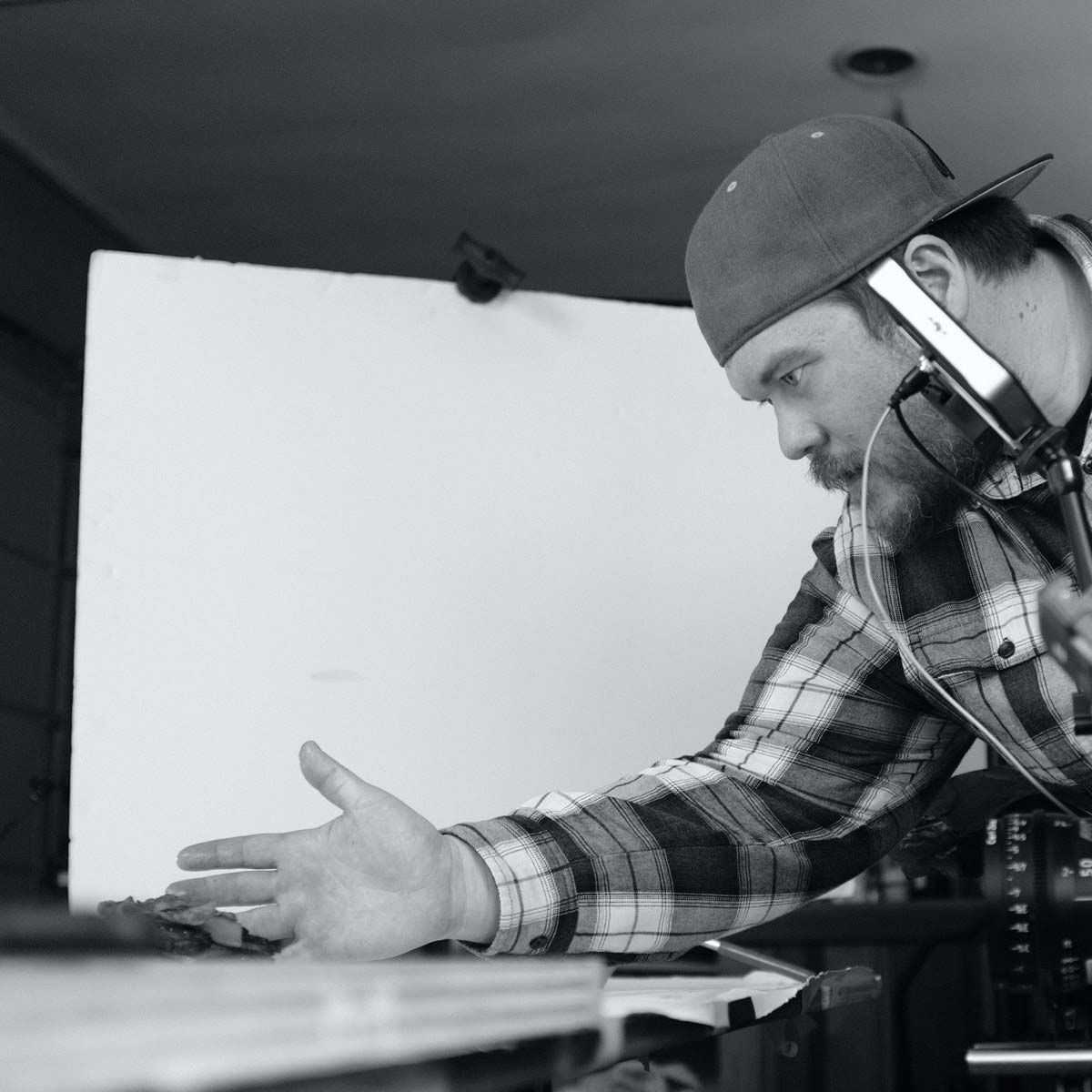 Photograph of a P+N employee setting up a shot.