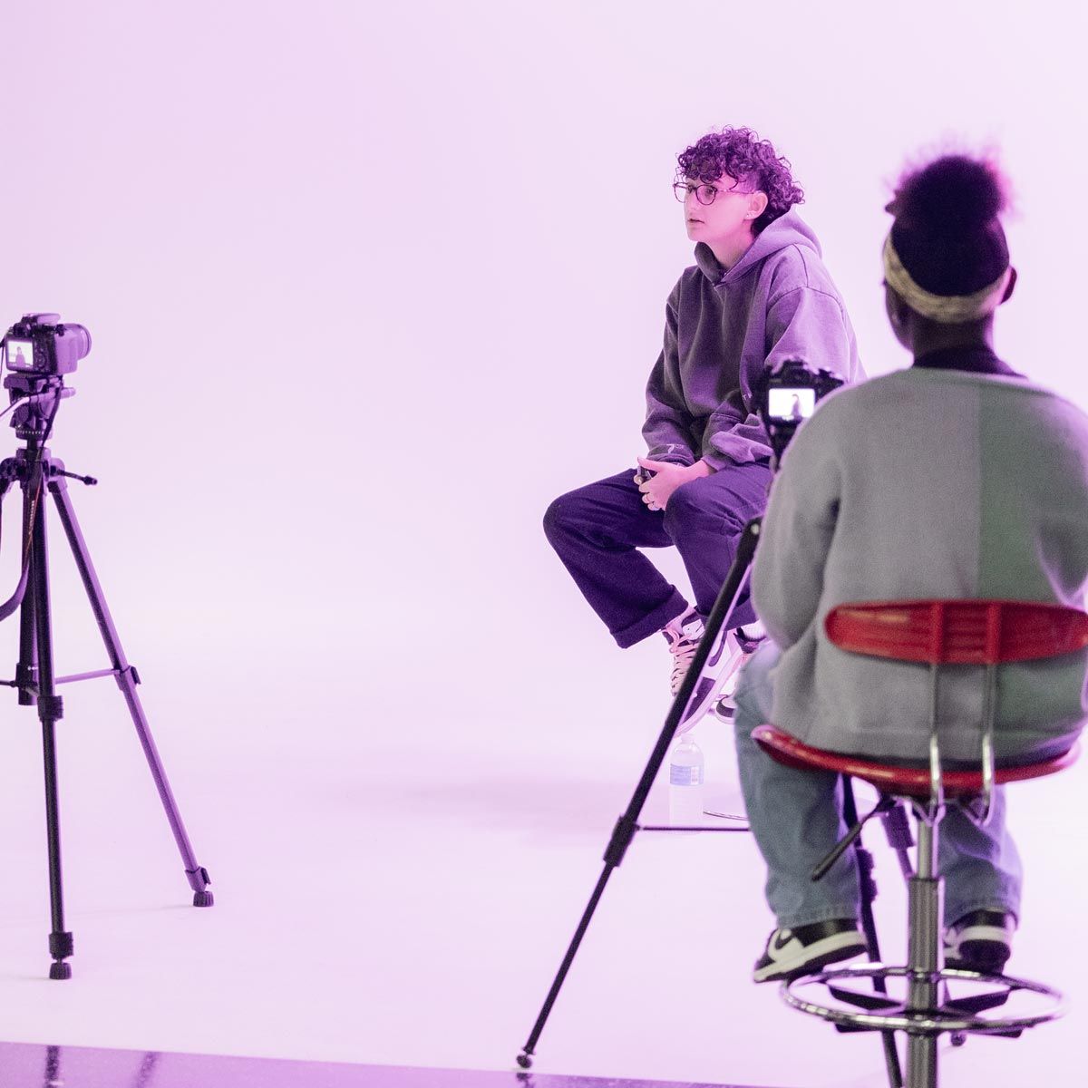 Photograph of employees filming a mock interview with students.