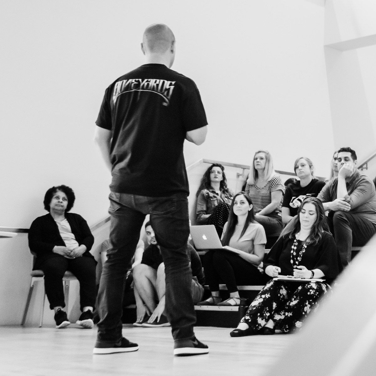 Photograph of Rob Kottkamp giving a presentation to employees on the stairs in the office.