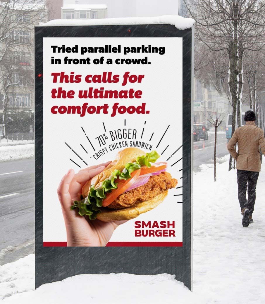 Photograph of a bus stop poster: "Tried parallel parking in front of a crowd. This calls for the ultimate comfort food."