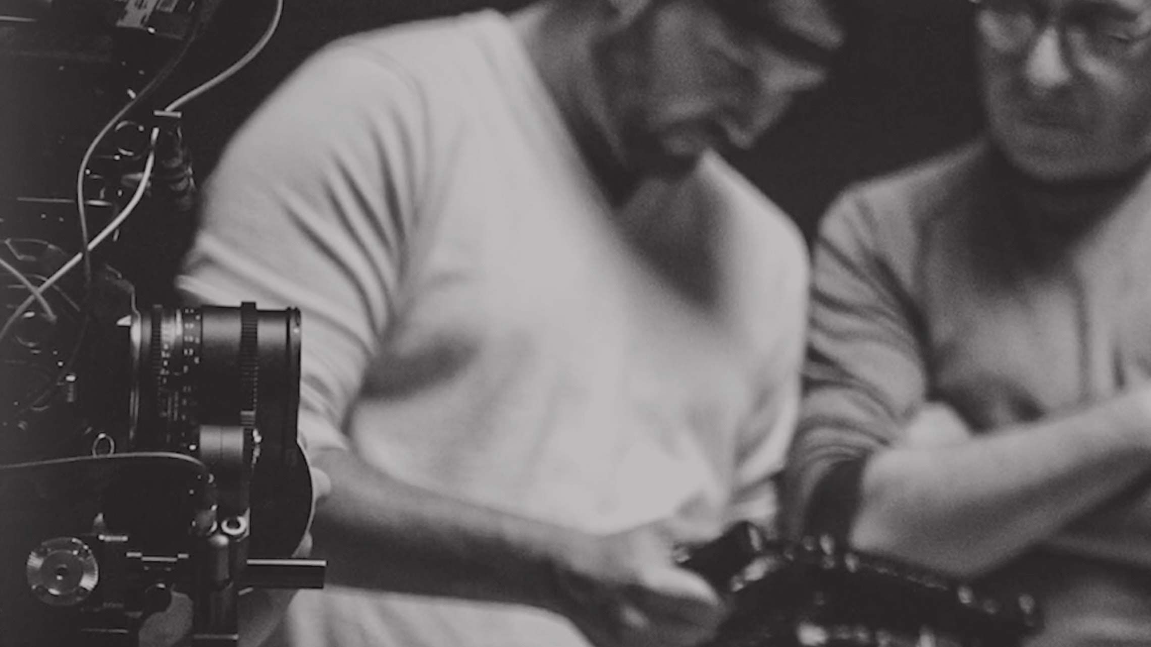 Image of two people working in front of a camera. Click to view the demo reel.
