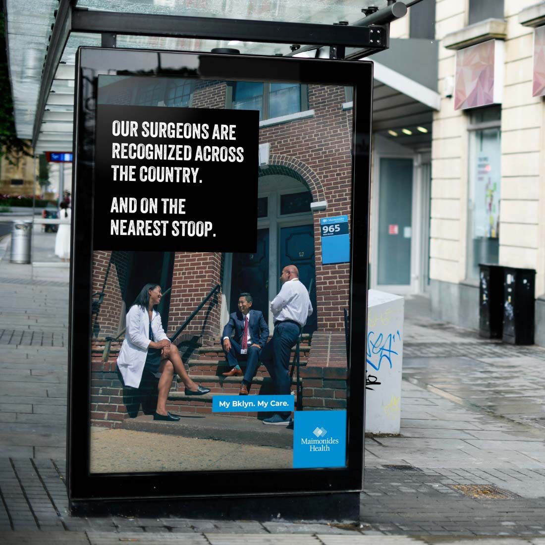 Photograph of Maimonides advertisement at a bus stop that says, "Our surgeons are recognized across the country. And on the nearest stoop."