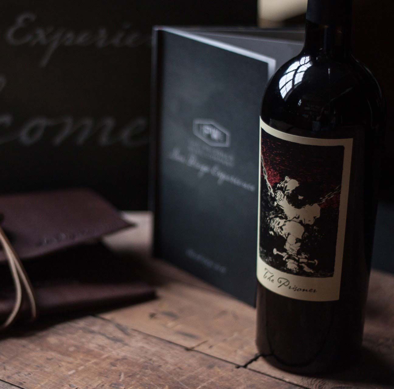 Photograph of event collateral next to a bottle of Prisoner wine.