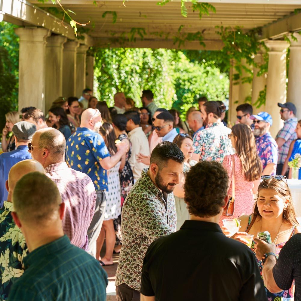 Photograph of employees mingling at an outdoor event.