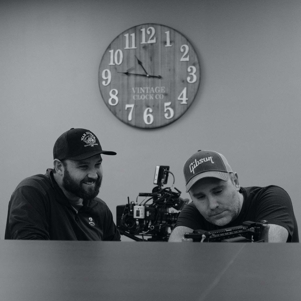 Photograph of two P+N employees setting up a video camera.