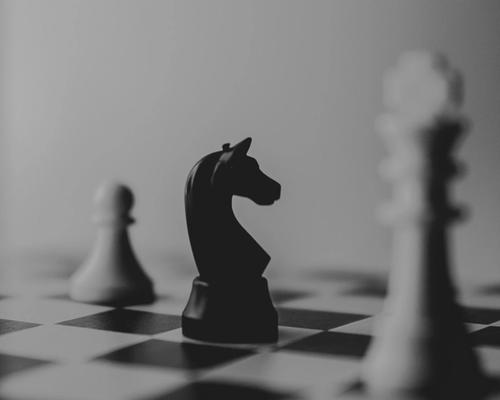 Chess pieces mid-game on a board