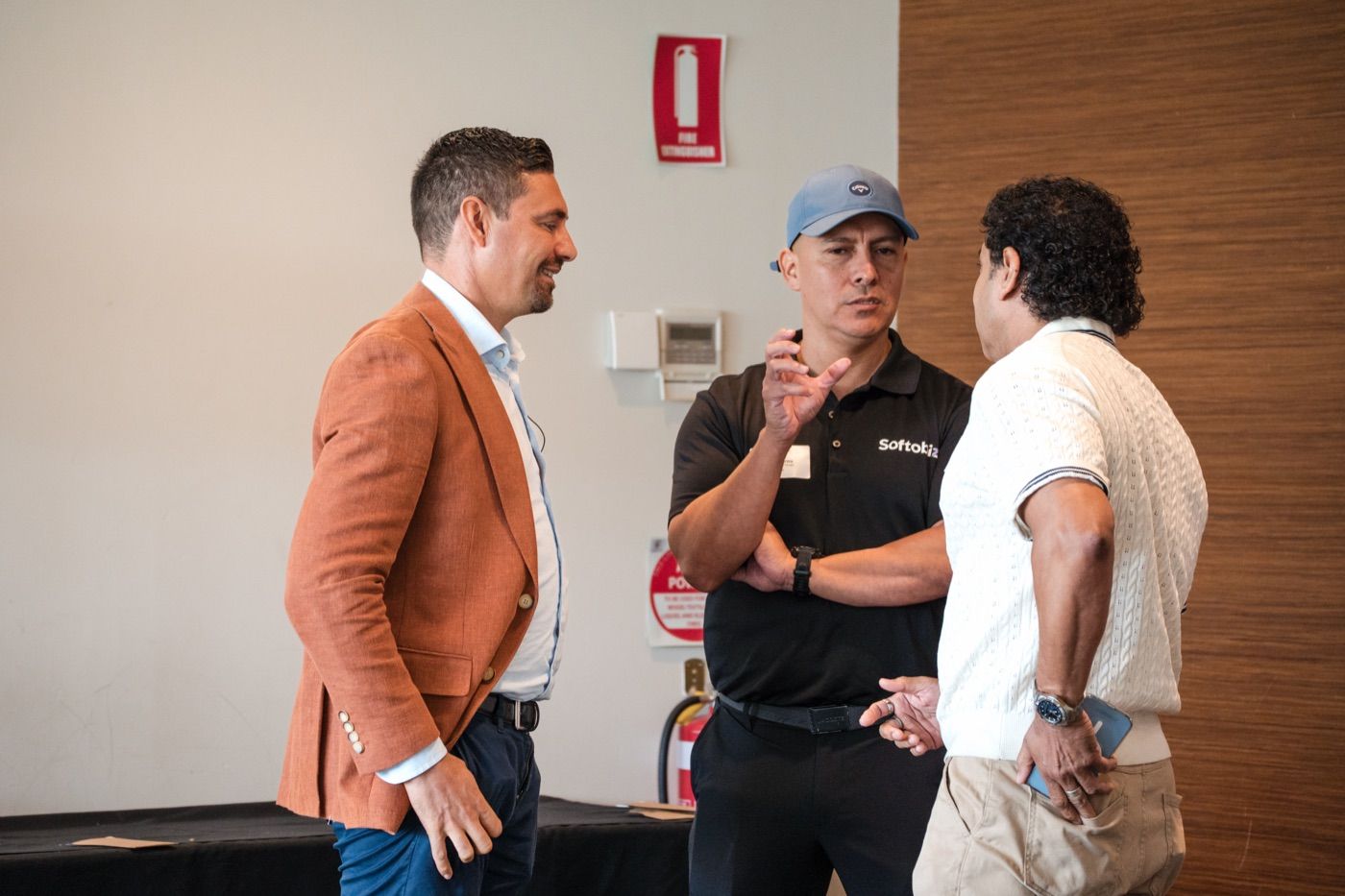 Softobiz and client leaders continuing a technology discussion between conference sessions