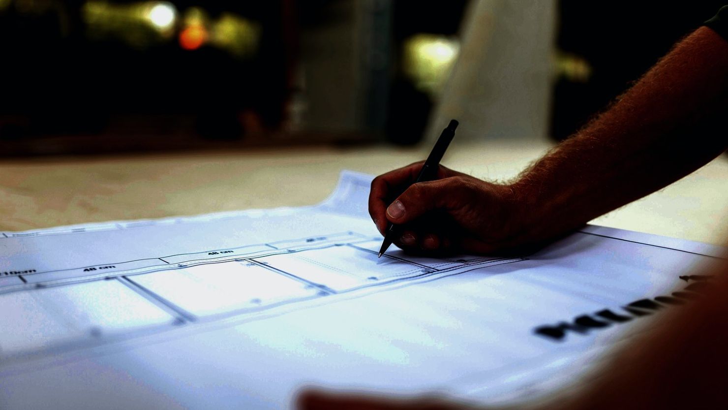 A transformation lead marks investment dependencies and expected outcomes on a working plan