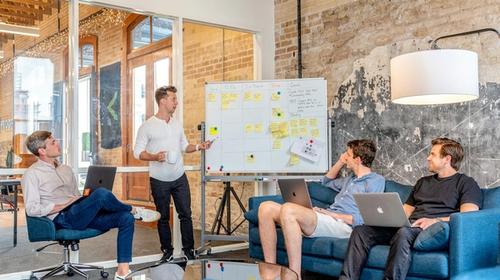 Delivery team working through a session at a whiteboard