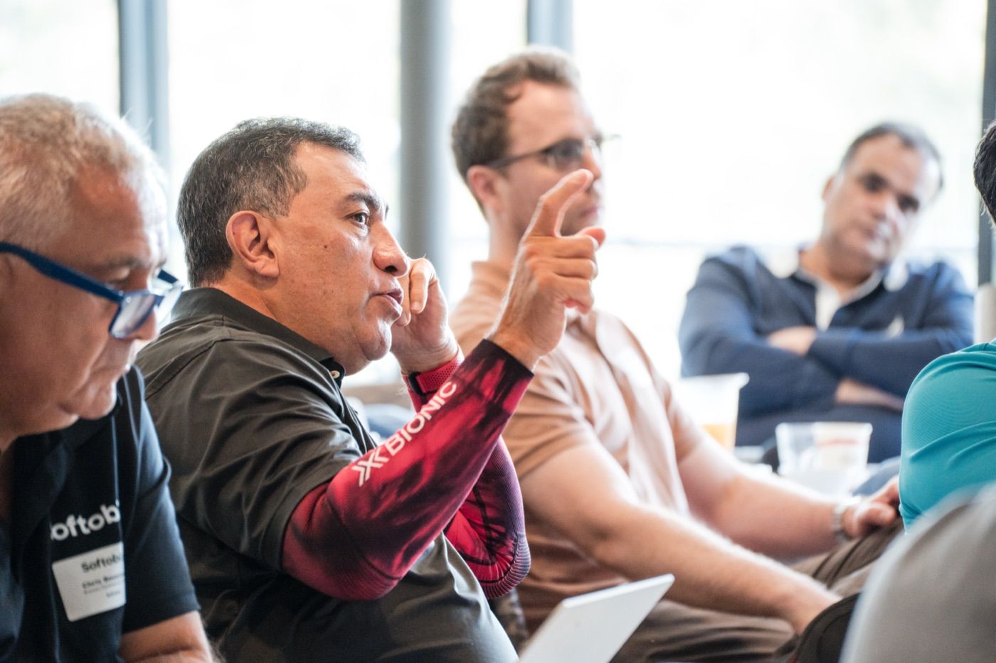 Senior business and technology leaders discussing priorities around a roundtable