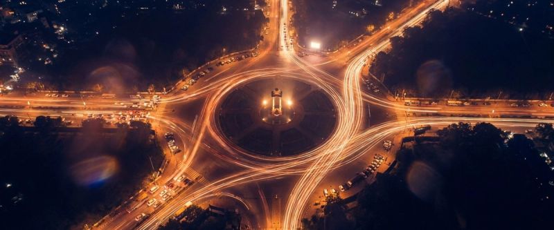 Traffic light-trails converging at a New Delhi junction at night