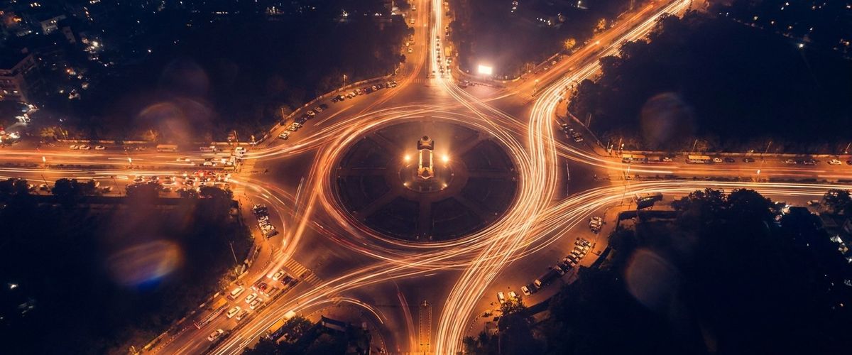 Traffic light-trails converging at a New Delhi junction at night