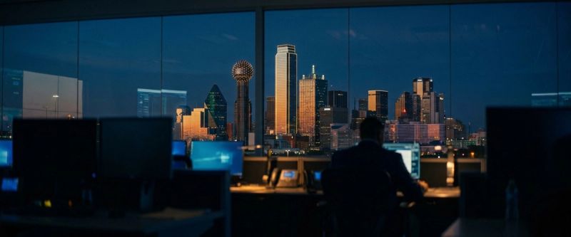 The Dallas skyline at blue hour from a glass operations facility