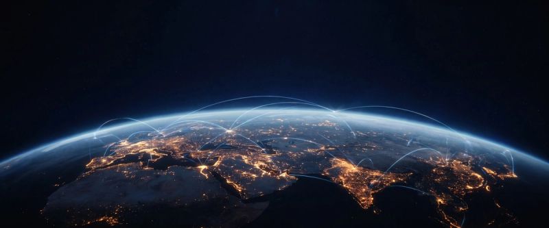 Earth at night from orbit, city lights tracing the continents